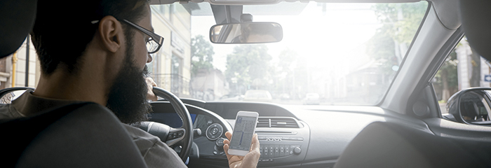 Man using mobile phone while driving.